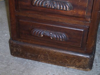 Damage to the wooden drawer handle.